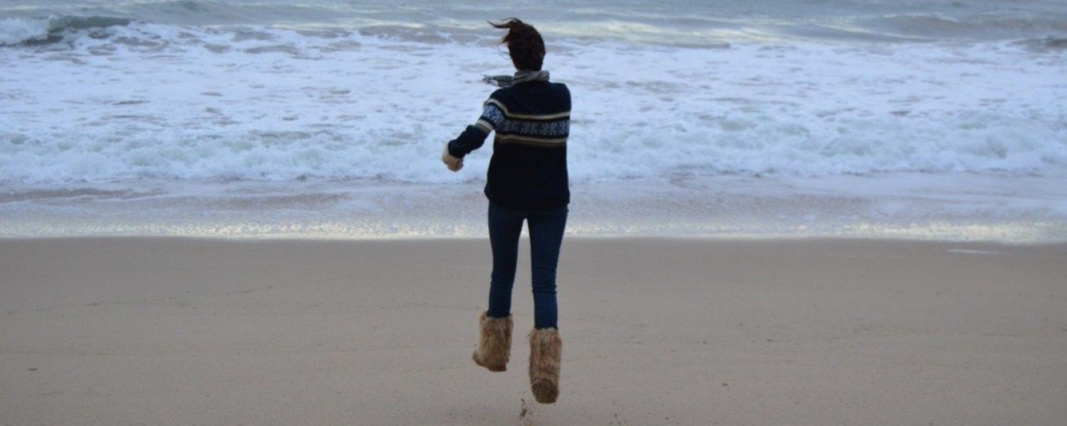 entusiasmo chica saltando playa